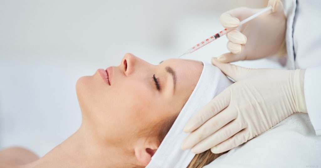 Woman getting BOTOX® in her forehead. (MODEL)